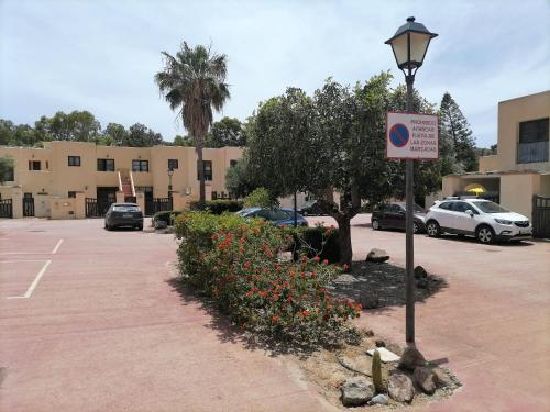 a parking lot with a parking sign and a street light at Casa El Sotillo in Almería