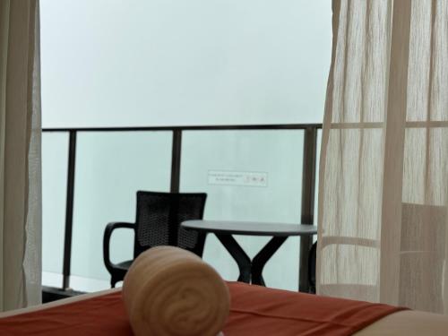 a room with a bed and a table and a window at The Minnook Suites, Genting Highlands in Genting Highlands