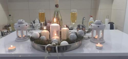 a table with candles and christmas decorations on it at Đurđevak lux in Banja Koviljača