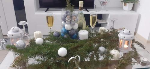 a christmas tree on a counter with glasses of champagne at Đurđevak lux in Banja Koviljača