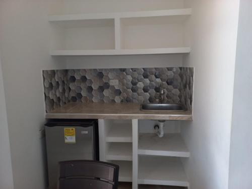 a kitchen with a counter and a sink in a room at Avadia del Mar in Cartagena de Indias
