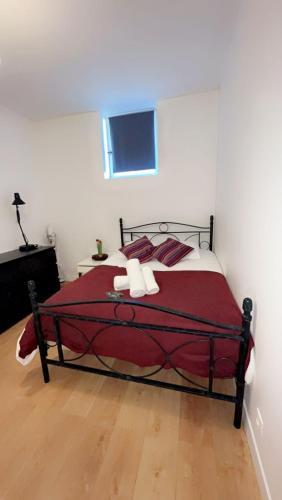 ein Schlafzimmer mit einem Bett mit einer roten Decke in der Unterkunft Appart toulousaine avec patio rdc in Aucamville