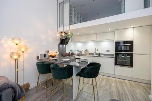 a kitchen with a table and chairs in a room at Your Home Away From Home in Manchester