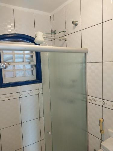 a shower with a glass door in a bathroom at Pousada Recanto da Cleide in Paraty