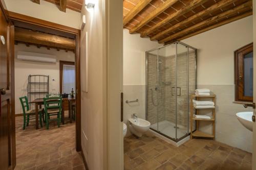 a bathroom with a glass shower and a sink at Podere Valserena in Monteroni dʼArbia