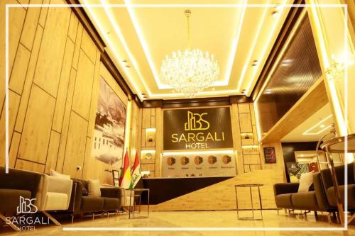 a lobby with chairs and a chandelier in a building at Sargali Duhok Hotel in Duhok