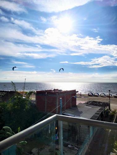two kites flying in the sky over the beach at Avadia del Mar in Cartagena de Indias