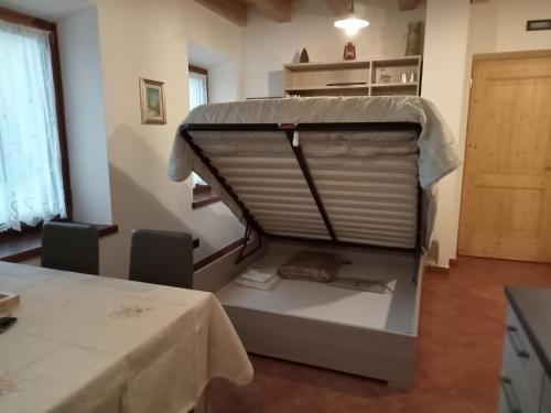 a room with a bed with a table and a table and a table at Appartamenti Bion in Levico Terme