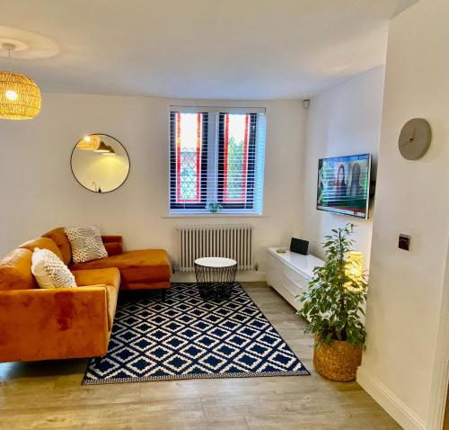 a living room with a couch and a table at Boutique Chapel Apartment within City Walls in Chester
