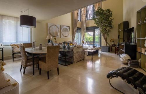 a large living room with a table and chairs at Spectacular villa with pool in Madrid and privacy in Madrid