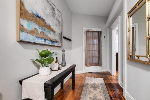 a dining room with a table and a painting on the wall at E1 Centrally located in Carytown fully fenced in Richmond