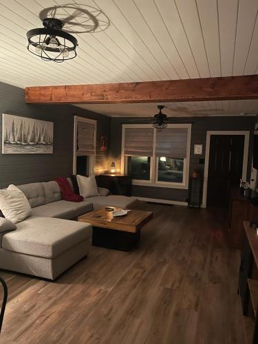 a living room with a couch and a table at Riverside Retreat in Benton Harbor
