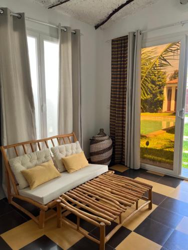 a couch in a room with a large window at Keur Ama in Mbour