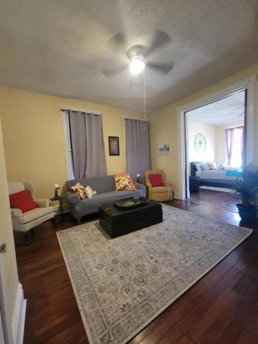 a living room with a couch and a table at Spacious One Bedroom Apartment in Soulard