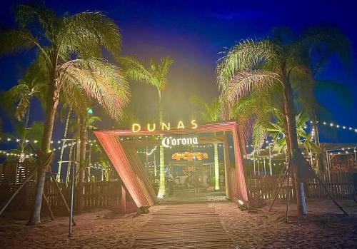 a entrance to a dumas casino with palm trees at Luxury in the Tropics that Sleeps 6 in El Chirú