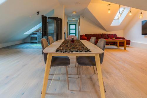 a dining table and chairs in a living room at Apteegimaja Apartment in Rõngu
