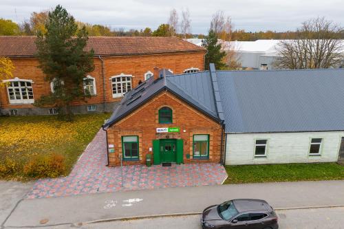 a building with a car parked in front of it at Apteegimaja Apartment in Rõngu
