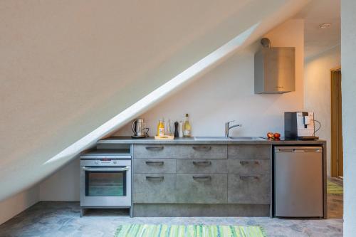 a kitchen with a sink and a stove at Apteegimaja Apartment in Rõngu