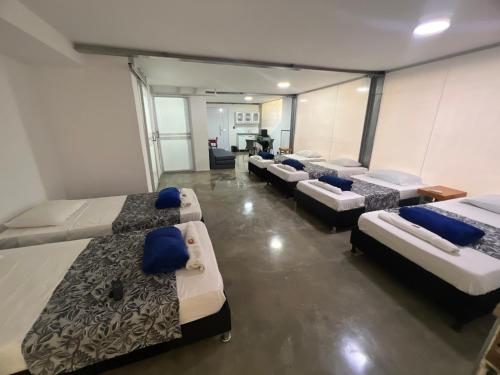 a room with a bunch of beds in it at Apartamento para grupos grandes dentro de centro comercial con frisby in Cartago