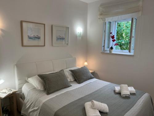 a bedroom with a large bed with towels on it at Luxury Apartment Spa "Marina" in Makarska