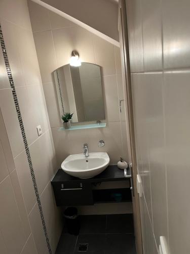 a bathroom with a sink and a mirror at Luxury Apartment Spa "Marina" in Makarska