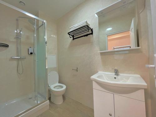 a bathroom with a toilet and a sink and a shower at KoalaWakeup in Vitry-sur-Seine