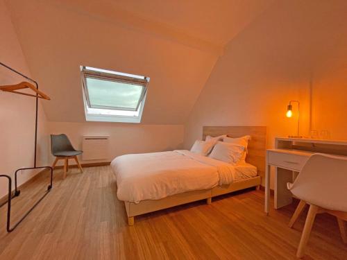 a bedroom with a bed and a desk and a window at KoalaWakeup in Vitry-sur-Seine