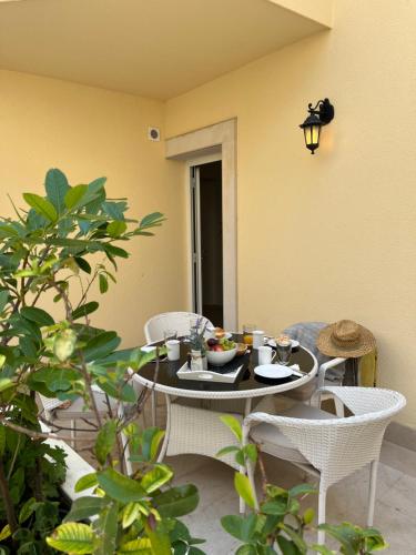 a table and chairs with a bowl of food on it at Luxury Apartment Spa "Marina" in Makarska