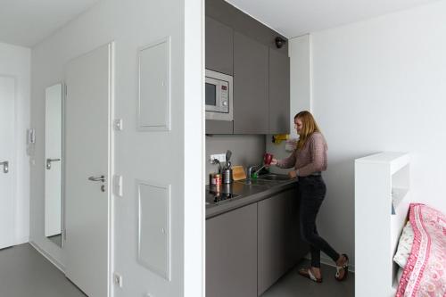 a woman standing in the kitchen of a house at Holiday Home Munich in Munich