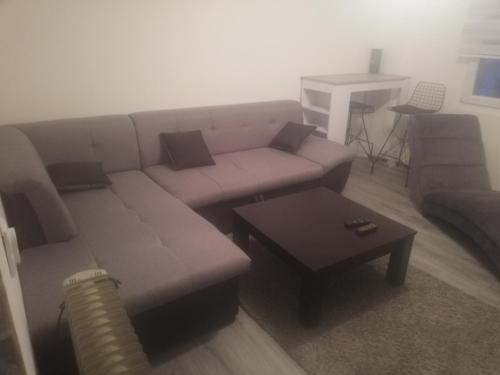 a living room with a couch and a coffee table at Apartman Ivana in Užice