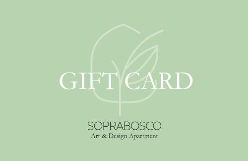 a gift card with a green leaf logo at SopraBosco Calcata Art & Design Apartment in Calcata