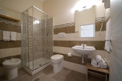 a bathroom with a toilet and a sink and a shower at hotel villaggio Casarossa in Crotone