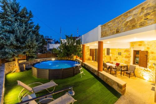 a house with a swimming pool in the yard at Stone House in Astérion