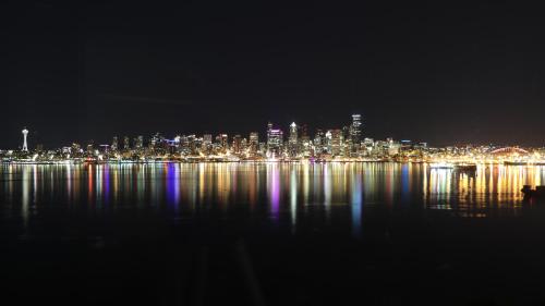 a night view of a city with lights on the water at 180 degree, unobstructed bluff view! in Seattle
