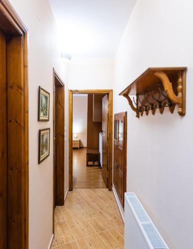 a hallway with white walls and wooden floors at Stone House in Astérion