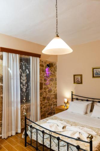 a bedroom with a large bed and a window at Stone House in Astérion