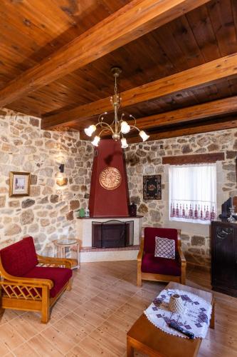 a large living room with a stone wall at Stone House in Astérion