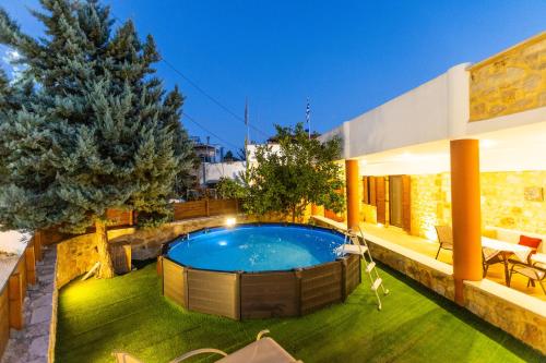 a swimming pool in the backyard of a house at Stone House in Astérion