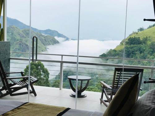 a room with a balcony with a view of a mountain at Ella HIDE VIEW in Ella