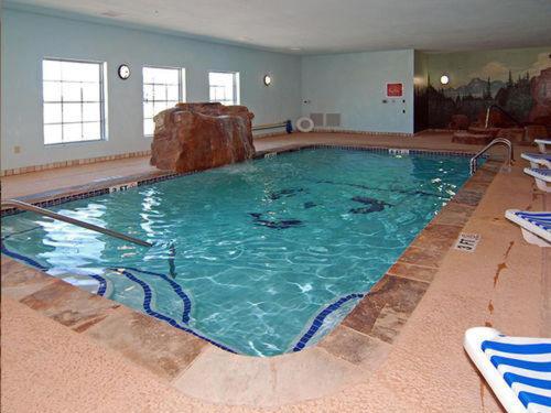 a large swimming pool with a rock in it at Hometown Executive Suites in Bridgeport