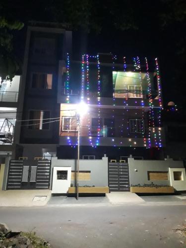a building with christmas lights on the side of it at Aashiyana Home Stay, Arera Colony, Bhopal in Bhopal