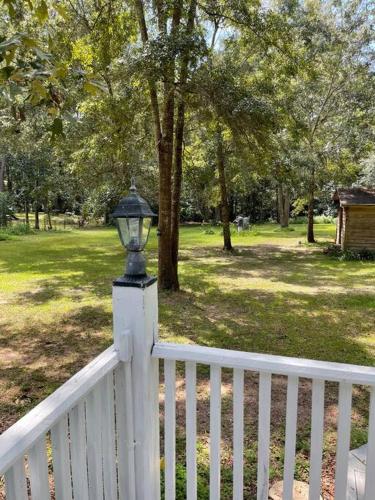 a white fence with a street light on top of it at Town & Country Hideaway - 1BR/1BA, 20 min FAMU/FSU in Tallahassee