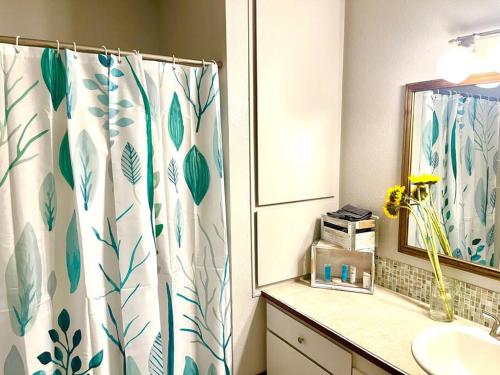 a bathroom with a shower curtain and a sink at Town & Country Hideaway - 1BR/1BA, 20 min FAMU/FSU in Tallahassee