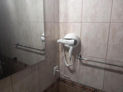 a white phone on a wall in a bathroom at Apartment Filipovic in Podgorica