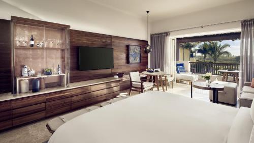 a hotel room with a bed and a television at Four Seasons Resort Punta Mita in Punta Mita