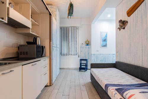 a small kitchen with a bed in a room at IM INTERNATIONAL 1 - Galleria Raggio 3/9 in Rapallo