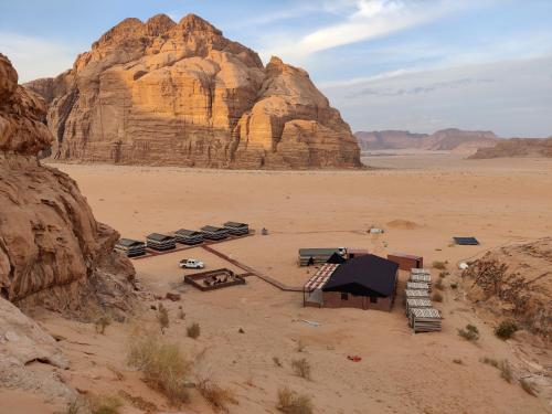 a camping area in the desert with a mountain at Rehana rum camp in Wadi Rum