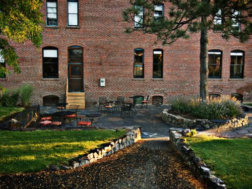 a brick building with a table and chairs in front of it at Balch Hotel in Dufur