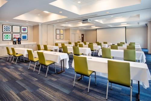 a room with tables and chairs in a classroom at Holiday Inn Express Hotel & Suites Rochester Webster by IHG in Webster