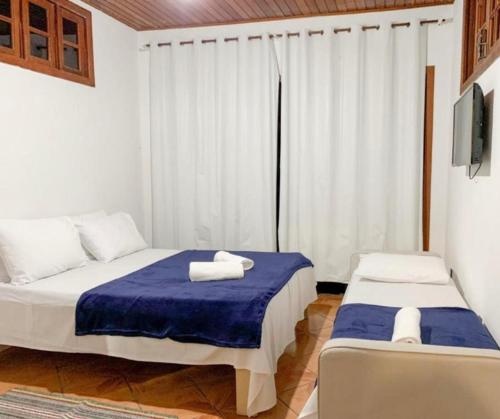 a bedroom with a bed with towels on it at Golden Residence in Florianópolis